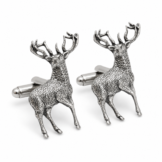 A pair of pewter cufflinks shaped like standing stags with detailed antlers and textured bodies, shown on a clean white background.