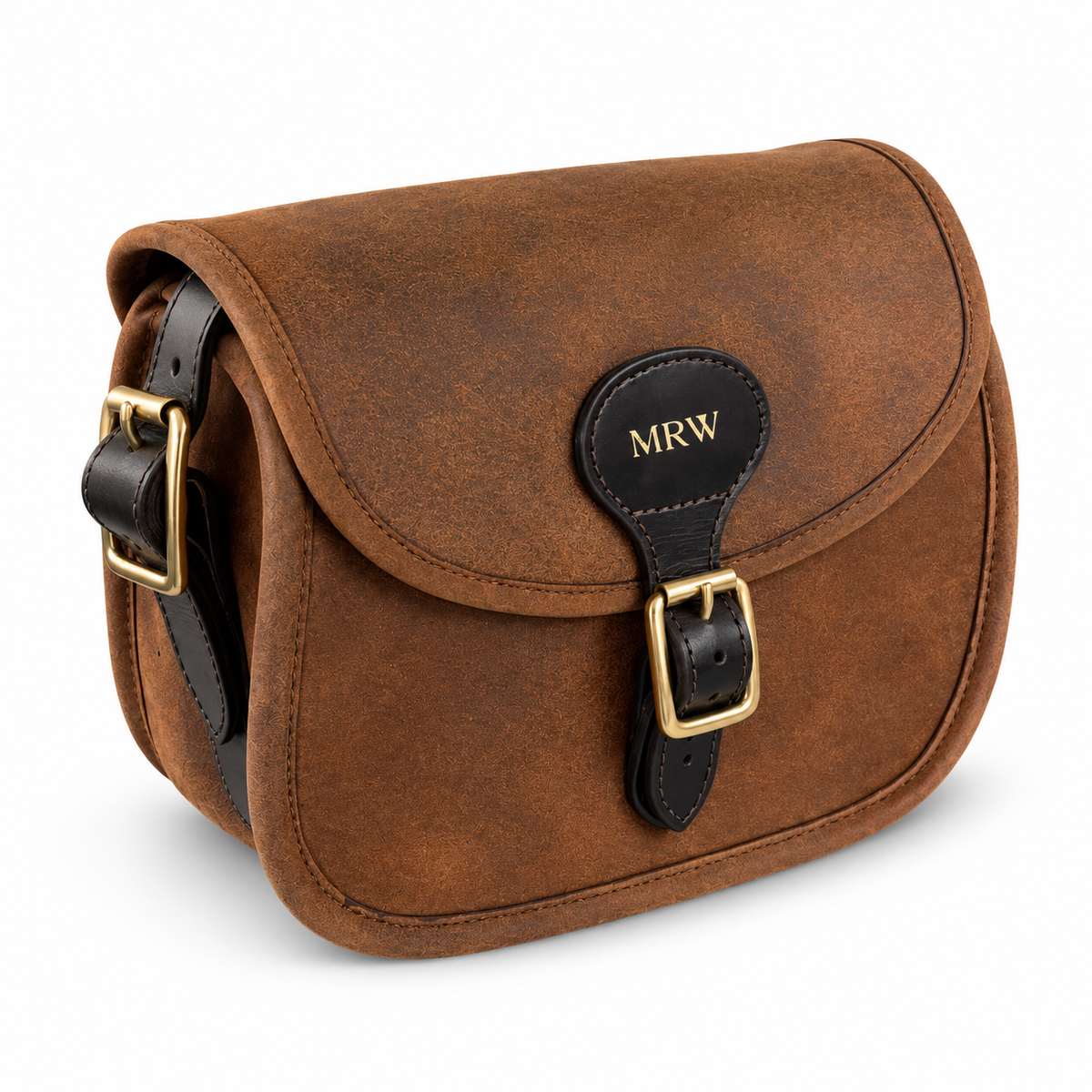 A brown leather cartridge bag with black leather strap and gold-tone hardware, featuring a personalized 'MRW' monogram patch on the front flap, set against a plain white background.