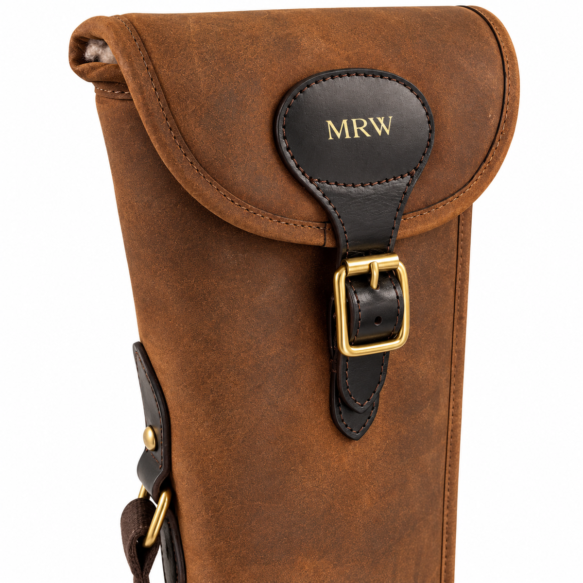 Embossing details on the front of a leather gun slip case photographed on white.