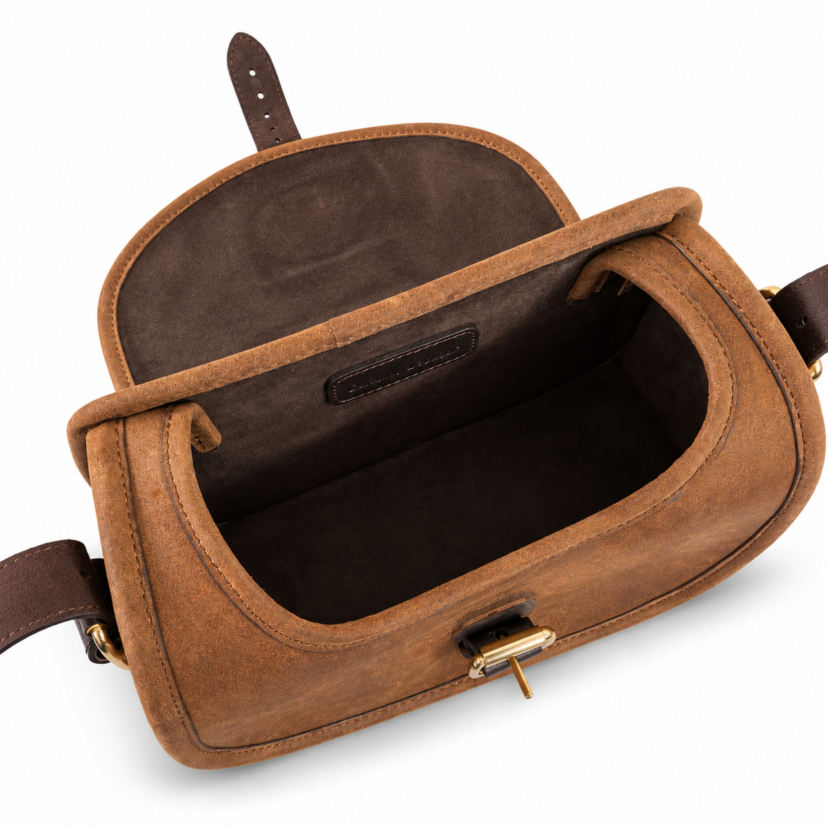 A brown leather cartridge bag shown open to display its interior, featuring a dark brown suede-like lining, brass hardware, and a strap visible on both sides against a white background.