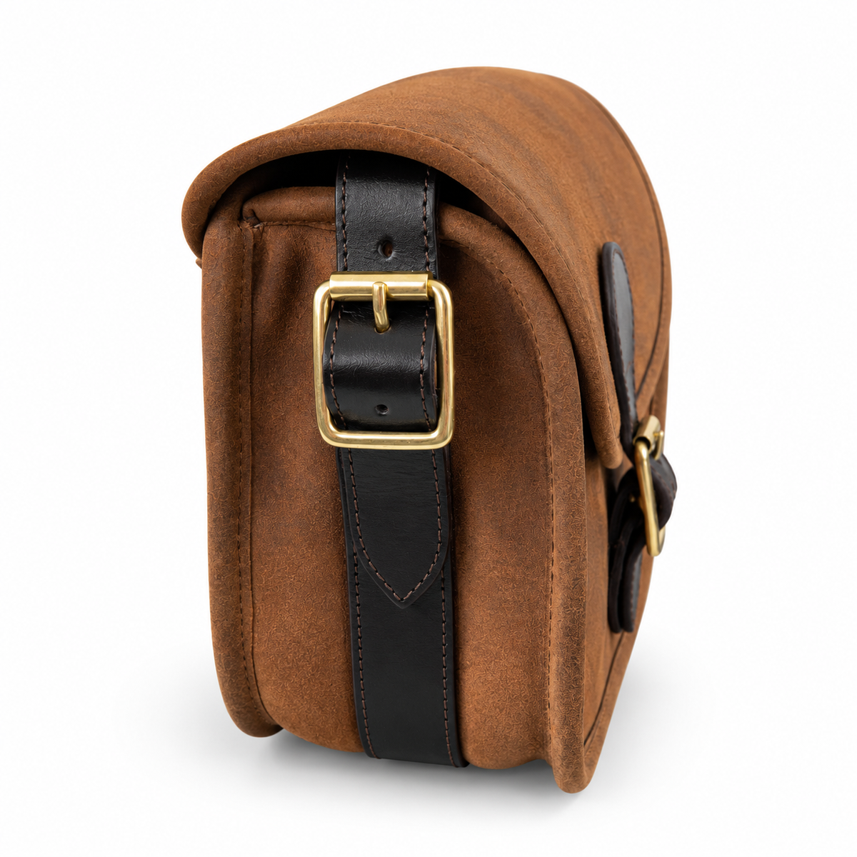 Side on of a brown leather cartridge bag with black leather strap and gold-tone hardware,  set against a plain white background.