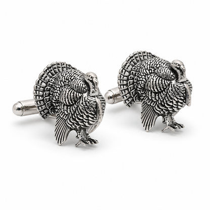 A pair of pewter cufflinks shaped like turkeys, shown on a clean white background.